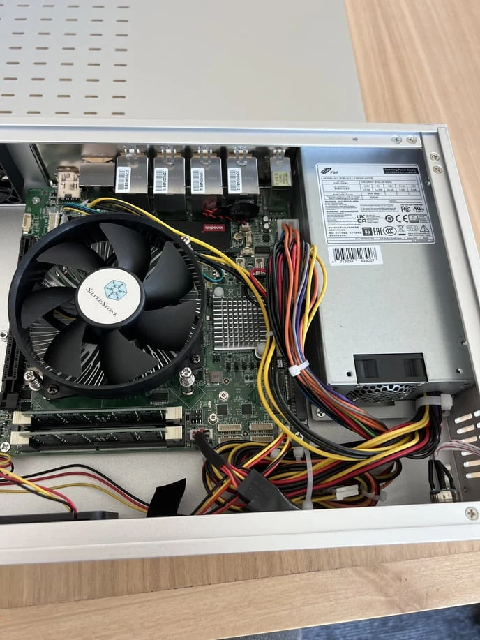 The open robot showing the motherboard, its fan, the modems, and the power supply on the right